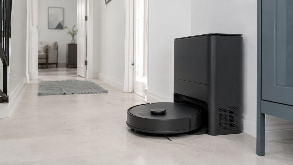 Robot vacuum cleaner near an auto-empty dock in a modern home.